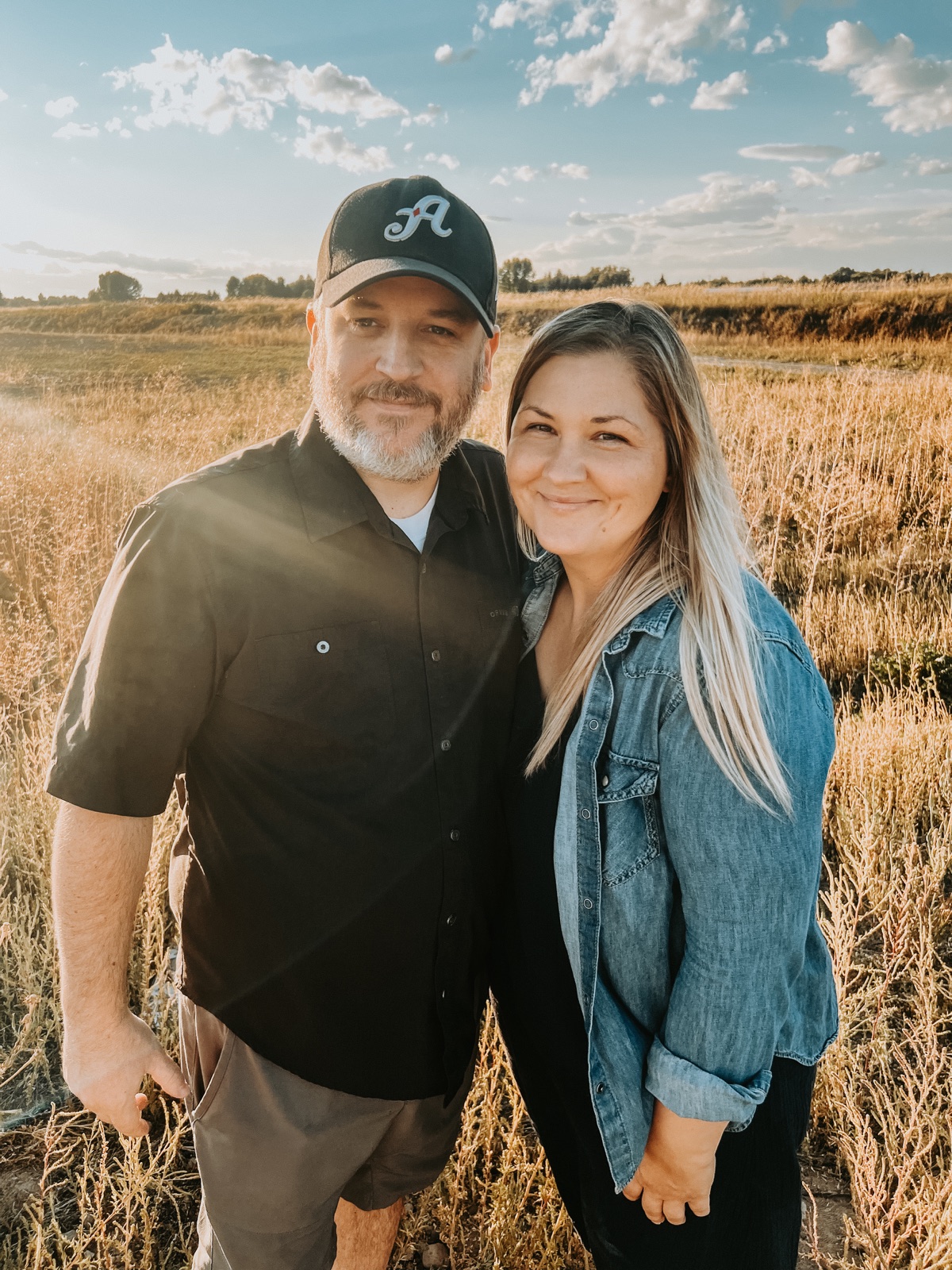 Derek and Maggie together in a sunlit field.